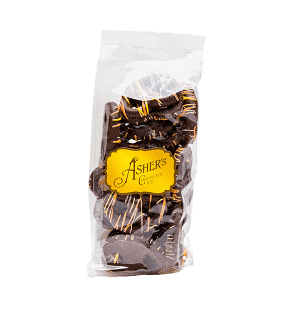 A 4 oz. bag of Dark Chocolate Fall Mini Pretzels, each crisp treat coated in rich dark chocolate and adorned with a festive orange drizzle, sits against a plain white background. The clear plastic bag is sealed at the top and features an Ashers Chocolate Co. yellow sticker on the front.