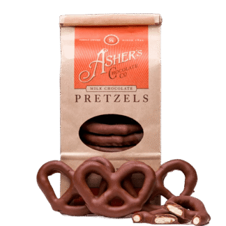 A bag of Milk Chocolate Covered Pretzel Coffee Bag with several whole and broken pretzels displayed in front.