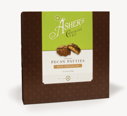 Milk Chocolate Caramel Pecan Patties Traditional Box with green and white Asher's Chocolate Co. Label. Two (2) Patties on the front of the box reveal, color, size, shape, and texture of candies. Displayed on white background.