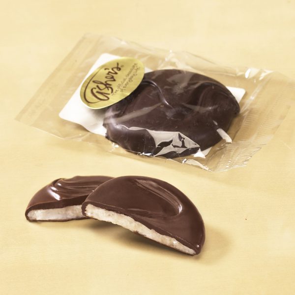 Hand Crafted Dark Chocolate Mint Patty Cello Bag. One (1) Patty is broken open to reveal the white mint inside. The second (2nd) pattie is wrapped in a clear cello bag with a gold Asher's sticker on the package.