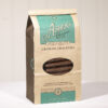 Milk Chocolate Graham Crackers Coffee Bag . Coffee Bag is brown with teal details. Clear plastic circular window on front displays Milk Chocolate Grahams inside. Shown on white background.