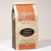 Coffee Bag is brown with orange details. Clear plastic circular window on front displays Milk Chocolate Pretzels stacked inside. Shown on white background.