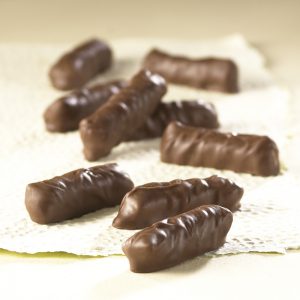 Milk Chocolate Pretzel Bites scattered in front of white backdrop, revealing candies shape, size, and chocolate texture.