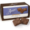 Milk Chocolate Mini Grahams Snack Box shown on white background. Snack box is brown with white and purple details. Two (2) Milk Chocolate Mini Grahams are shown outside of box to reveal color, size, and texture.