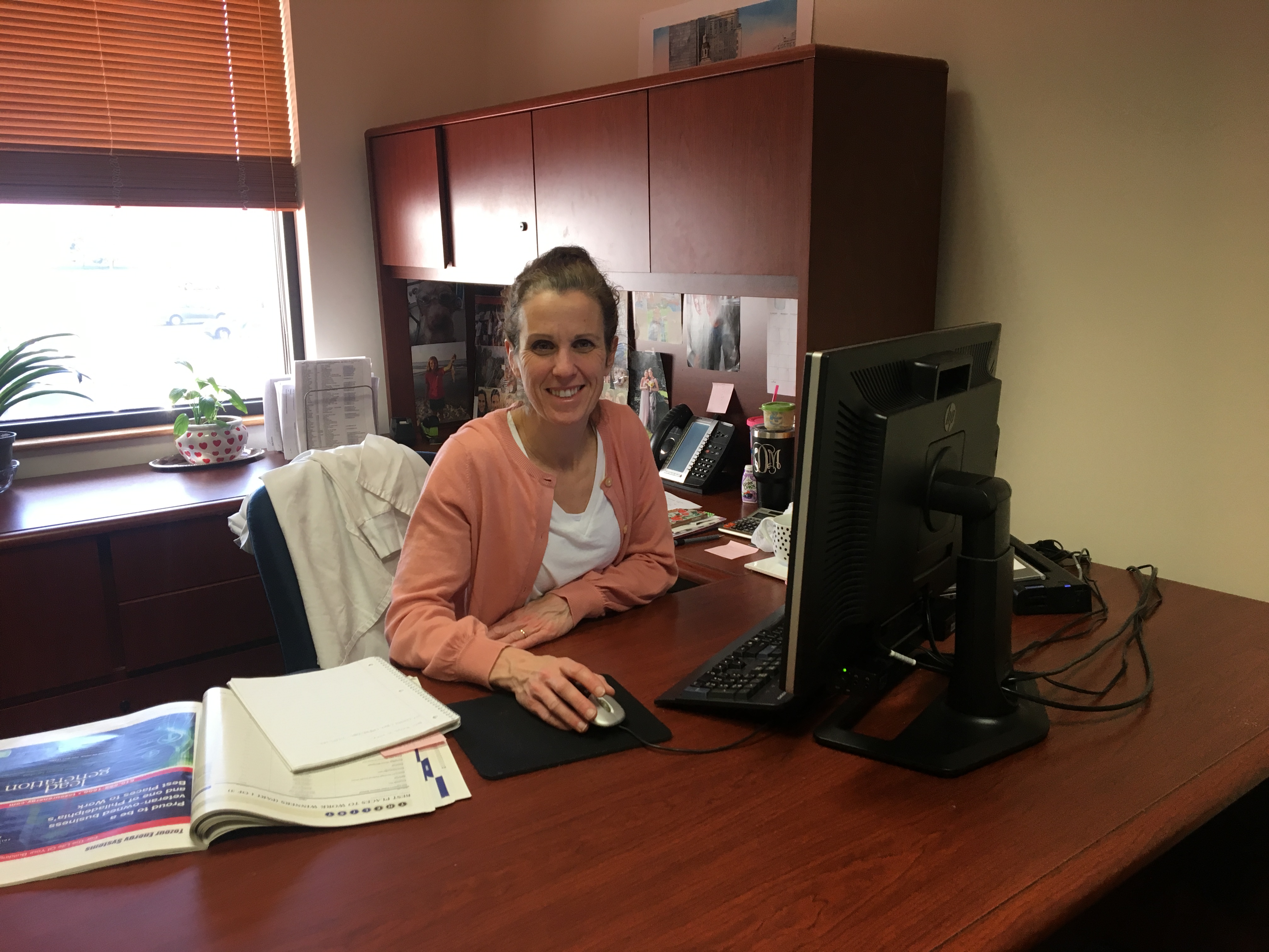 Asher's Chocolate Co.'s April employee highlight, Kris Derstein sitting at her desk, working hard as the operator and fulfiller of our online retail sales website.