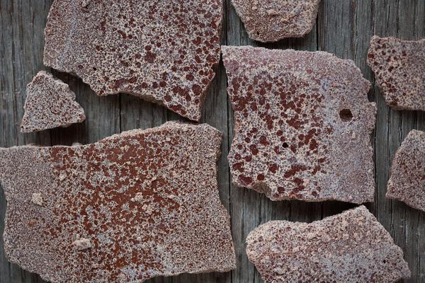 Broken pieces of chocolate with white chocolate bloom.