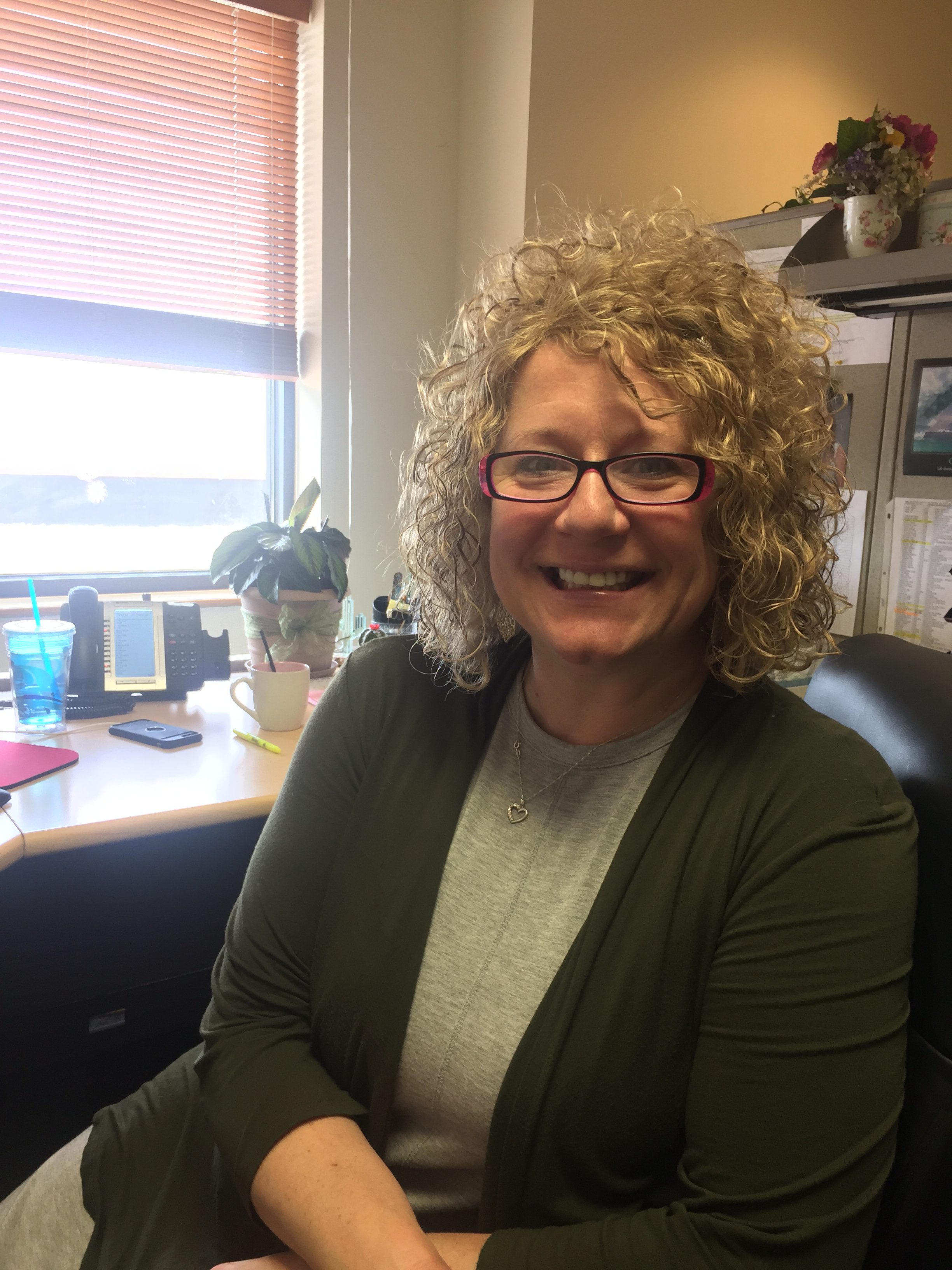 Asher's Chocolate Co. June Employee Highlight, Rachel Tomaino, sitting at her desk in the customer service department.